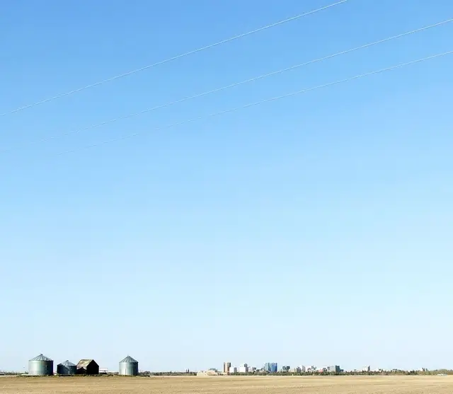 Farmland with Regina skyline in the distance